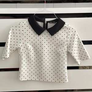 White top with black Polka dots and black collar